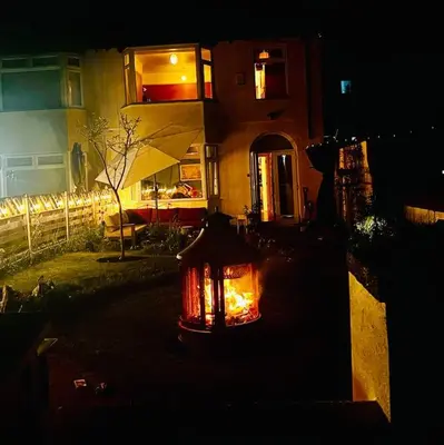a light in front of a house at night at Liverpool - Cosy Jazzy Beach Home! in Waterloo
