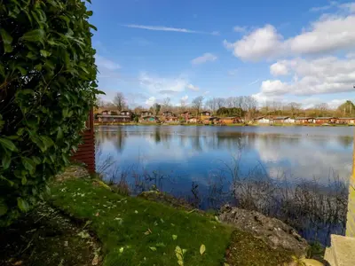 a view of a large lake with houses at Tiptoes Lodge in Carnforth