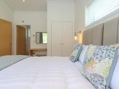 a bedroom with a large white bed with two pillows at Corning Mill View in Ulverston