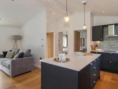 a kitchen and living room with a large island at Ash Thwaite in Ulverston