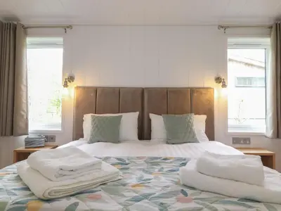 a bedroom with a bed with two towels on it at Ash Thwaite in Ulverston