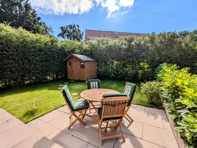 a patio with a table and chairs in a yard at Double Room l Large TV l Great Transport Links in Bolton