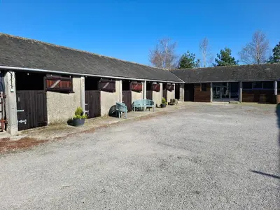 an empty parking lot in front of a building at Corner Cottage at Brackenthwaite Farm in Carnforth