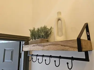 a shelf with a potted plant on top of a door at Shakespeare's Snug in Prescot