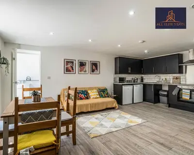 a living room with a bed and a kitchen at Swan House Apartment 5 - 2 Bed Apartment - Sleeps 6 - Free Parking - Liverpool - close to city centre - By ALL ELITE STAYS in Liverpool