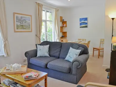 a living room with a couch and a table at Hope Cottage in Lindale