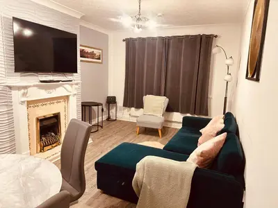 a living room with a couch and a fireplace at Entire Immaculate 3 Bedrooms House in Blackburn Weekend Away in Blackburn