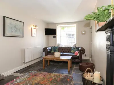 a living room with a couch and a table at Caton Lane House in Grange Over Sands
