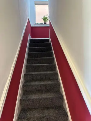 a stairway with a red wall and a red stair case at The Big One Blackpool in Blackpool