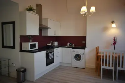 a kitchen with a washing machine and a microwave at Liverpool City Stays - Bold Street in Liverpool