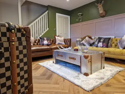 a living room with two couches and a table at The Hamilton luxury holiday let's- The Coach House with hot tub in Scorton