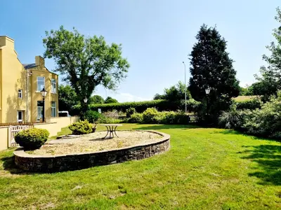 a garden with a bench in front of a house at Lord William in Preston