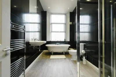 a bathroom with a tub and a toilet and a sink at Suite in the heart of Great Harwood in Great Harwood