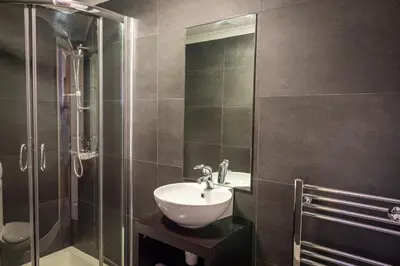 a bathroom with a sink and a glass shower at Lakeland Lodge 9B Arnside , Carnforth ,Lancaster , LA61BH in Carnforth