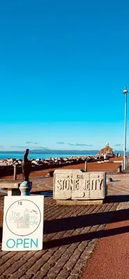 a sign on the beach with a bird sitting on top of it at Eden Stay in Morecambe