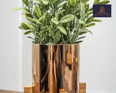 a vase with a plant in it on a table at Swan House Apartment 9 - 2 Bed Apartment - Sleeps 6 - Free Parking - Liverpool - close to city centre - By ALL ELITE STAYS in Liverpool