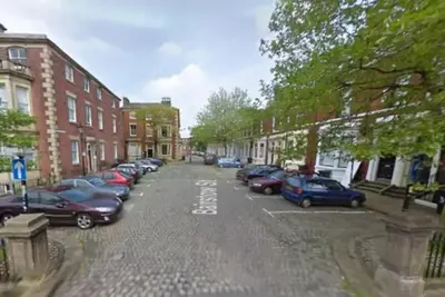 a city street with cars parked in a parking lot at Superking Size City Centre En-Suite Room + Parking in Preston