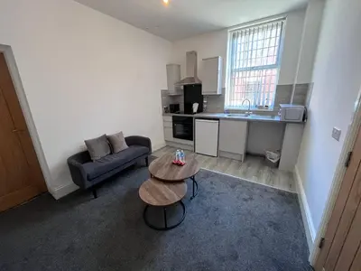 a small living room with a couch and a table at Riverside by Teil Luxurious one bed Apartment in Preston