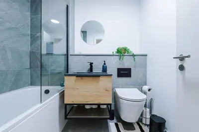 a bathroom with a sink and a toilet and a tub at Luxury King Size 1-Bed City Apartment - Free WI-FI in Preston