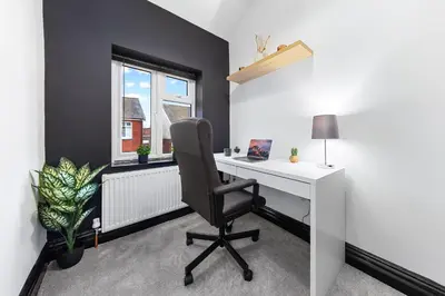 an office with a desk and a chair and a window at 2 Bed Flat - Sleeps 8 - Pets - Parking - Wifi in Blackpool