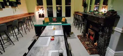 a living room with a fireplace and a bar at Single Room Shared bathroom Free Street Parking Near Anfield LFC in Liverpool