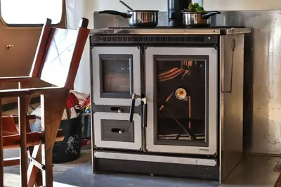 a stove with a door open in a room at Curlew - Bleasdale in Chipping