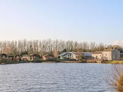 a view of a lake with houses and buildings at Ladybird Lodge in Carnforth