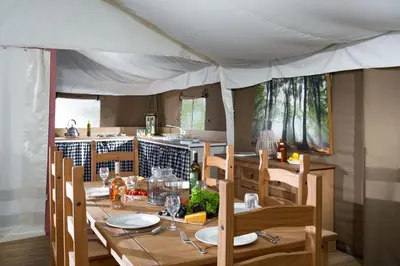 a dining room table with chairs and a table with plates at Mallard - Bleasdale in Chipping