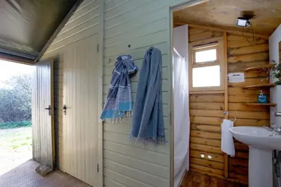a bathroom with a sink and a towel on the door at Plover - Bleasdale in Chipping