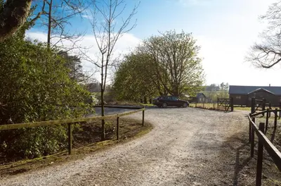 a dirt road with a fence and a car on it at Plover - Bleasdale in Chipping