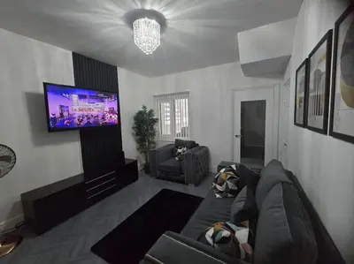 a living room with a couch and a flat screen tv at Lily in Blackpool