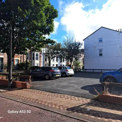 a group of cars parked in a parking lot at Red & Blue flat 15mins to Liverpool city centre, free parking in New Brighton