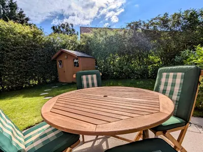 a wooden table with two chairs and a bird house at Cosy Single Room l Smart TV l 5 Minute Walk from Train Station in Bolton