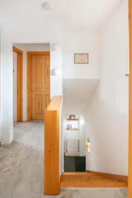 a room with white walls and a wooden stair case at Cosy Single Room l Smart TV l 5 Minute Walk from Train Station in Bolton