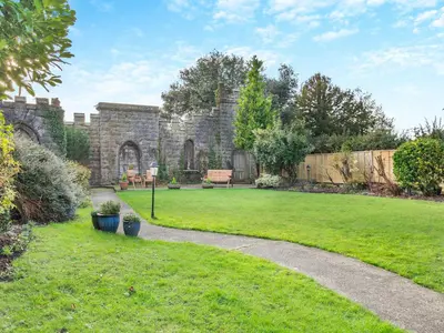 a garden with a stone building and a grass yard at Uk46866 - Hawkshead in Ulverston