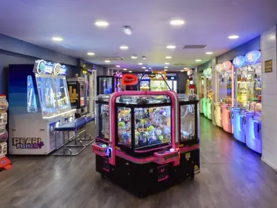 a video game arcade with several games in a room at Peachy in Heysham
