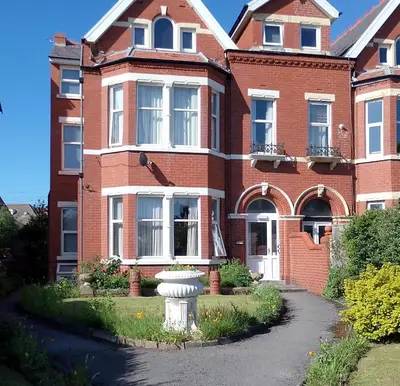 a brick house with a vase in front of it at St Annes Lodge Garden Flat AWARD WINNING HOSTS in Lytham St Annes