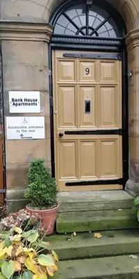 a large wooden door on the side of a building at The Rafters Bank House Stunning Apartment in Millom
