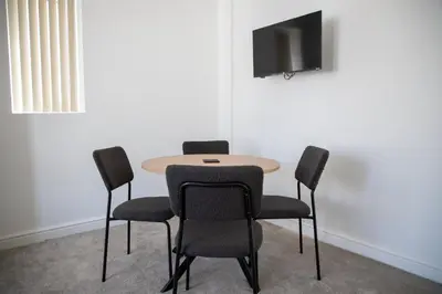 a table and chairs in a room with a tv at Balmoral Stays 3 - First Floor in Blackpool