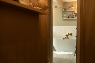 a bathroom with a tub and a toilet and a sink at Fern room at field view cottage in Eccleston