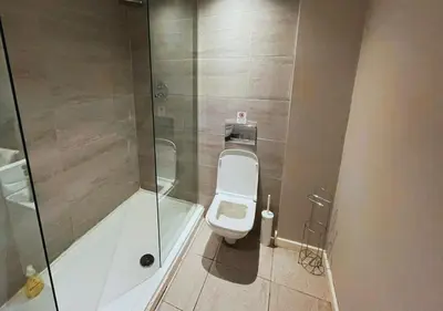 a bathroom with a toilet and a glass shower at Heritage Bank Liverpool Near Cavern sleeps 3 in Liverpool