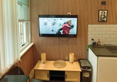 a living room with a tv hanging on a wall at Heritage Bank Liverpool Near Cavern sleeps 3 in Liverpool
