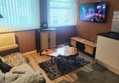 a living room with a couch and a tv at Heritage Bank Liverpool Near Cavern sleeps 3 in Liverpool