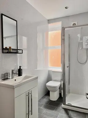 a bathroom with a toilet and a sink and a shower at Apartment 6 in Blackpool