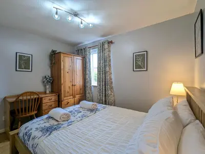 a bedroom with a bed and a desk and a window at City Centre Vintage Theme Guest Rooms in Liverpool