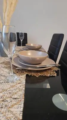 a table with plates and glasses on top of it at Accrington - House - Sleeps 10 - Garden in Accrington