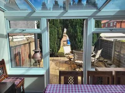 a screened in porch with a view of a patio at Cottage - Sleeps 4 - Garden - Parking in Chorley