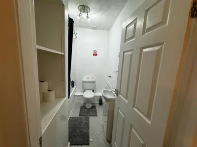 a white bathroom with a toilet and a door at Double Bed BW2 Accrington Burnley in Accrington