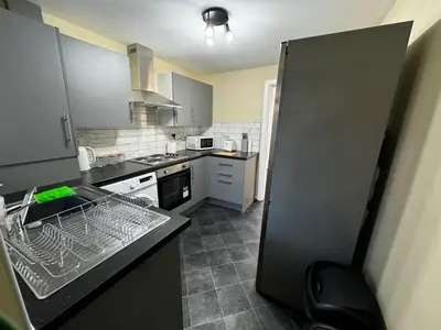 a kitchen with a sink and a refrigerator at Double bed BW4 Accrington Burnley in Accrington