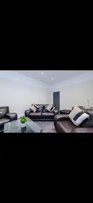 a room with leather beds and a glass table at Walton Residence in Liverpool